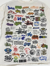 Stussy "All-Logos" A.O.P. T-Shirt Sz. L