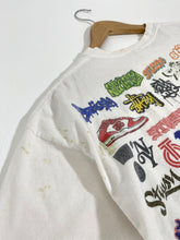 Stussy "All-Logos" A.O.P. T-Shirt Sz. L